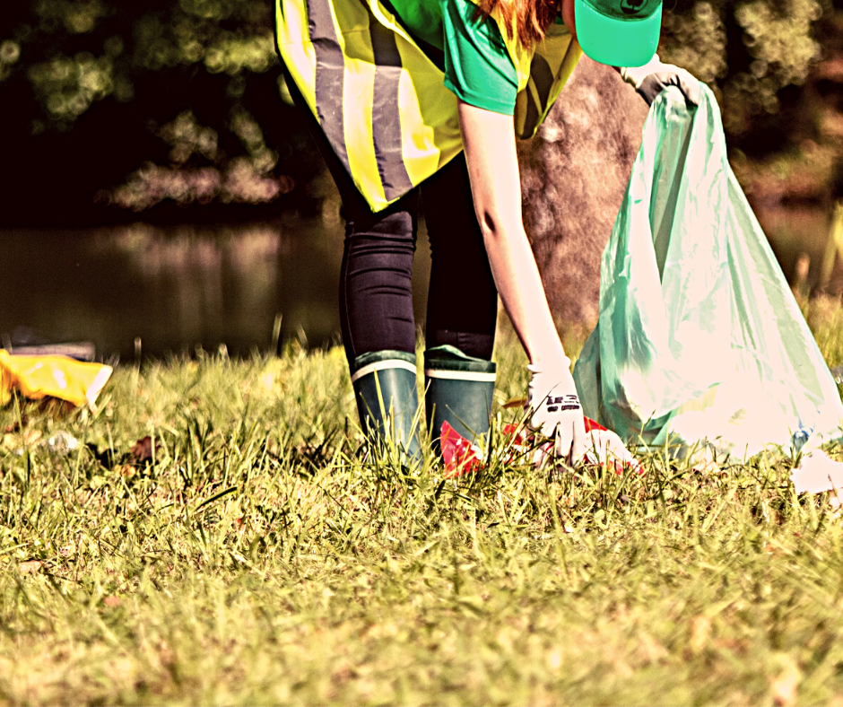 PERSON PICKING UP TRASH IN A PARK